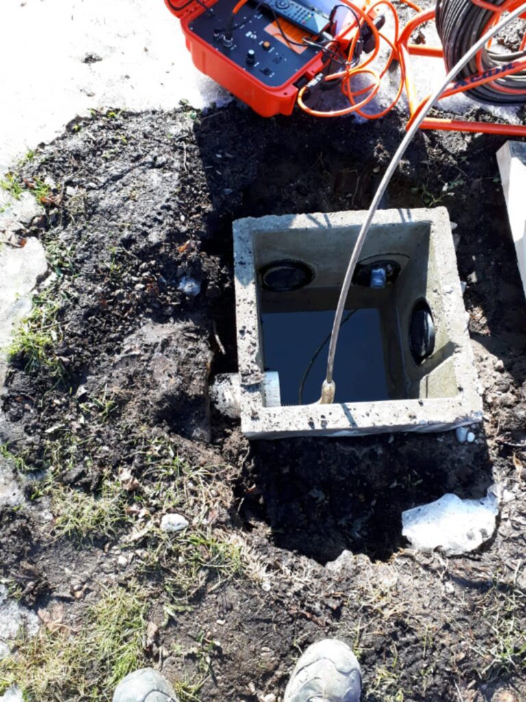 picture of a septic tank with a camera system inserted into it.