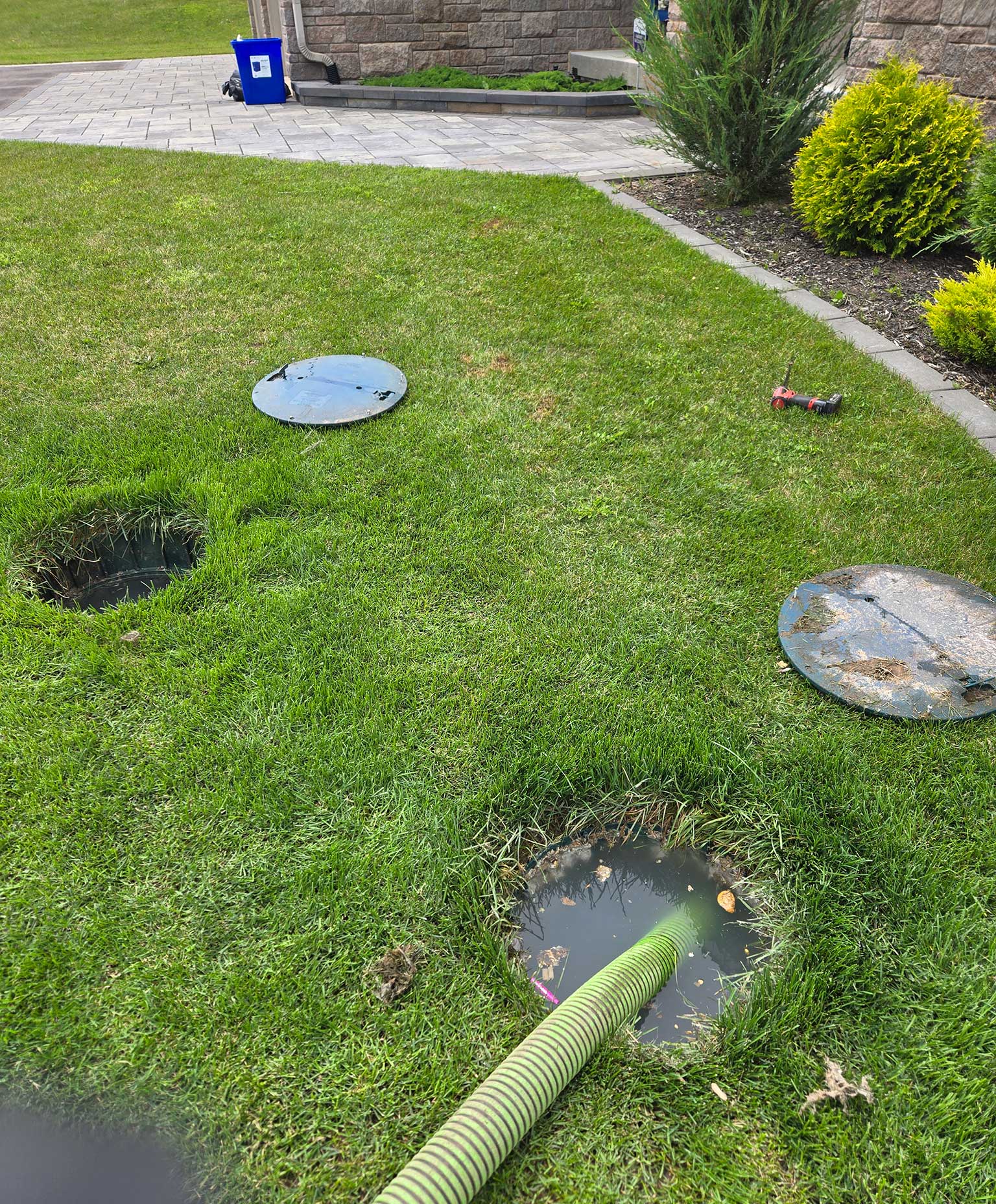 picture of a septic tank with both lids open and one tank is full